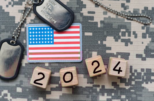 Top view of wooden cubes with letters VOTE over the American flag background. United States presidential election. Politics and voting conceptual photo