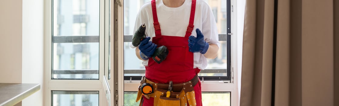 Construction worker installing window in house photo