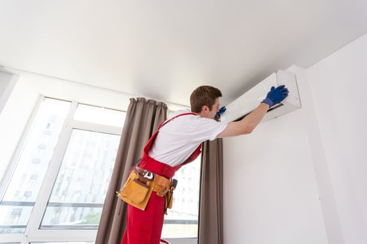 Service man is cleaning, repair and maintenance of air conditioner photo
