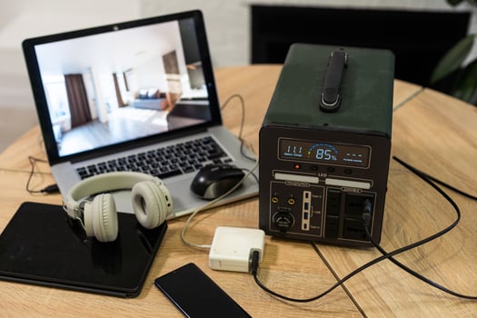 Portable power station charging devices on table in living room photo