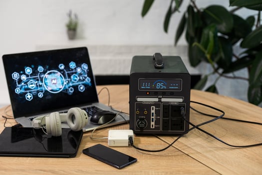 Portable power station charging gadgets near wall photo