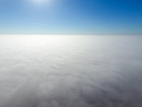 In the skies above the fog. Sunrise over the fog. Clouds near the ground photo