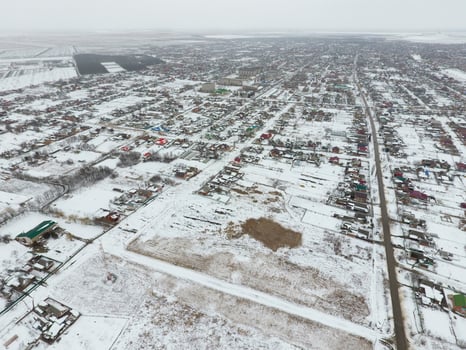 Winter view from the bird's eye view of the village. The streets are covered with snow photo