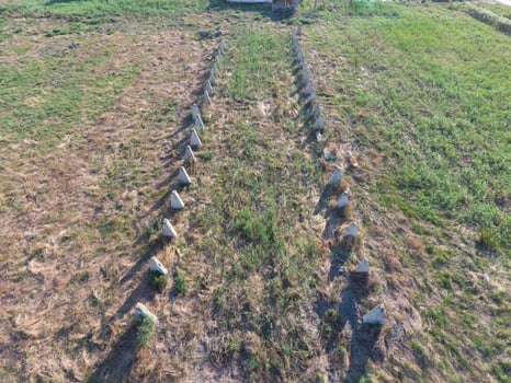The ruins of the old farm. Cones column base of the wall. Abandoned and ruined buildings photo