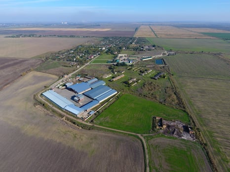 Top view of the village. One can see the roofs of the houses and gardens. Top view of the village with houses and hangars for the storage of grain. photo