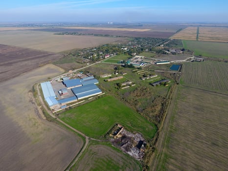 Top view of the village. One can see the roofs of the houses and gardens. Top view of the village with houses and hangars for the storage of grain. photo