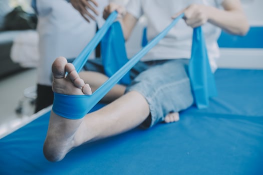 Doctor or physical therapist examines back pain and spinal area to give advice within the rehabilitation center. photo