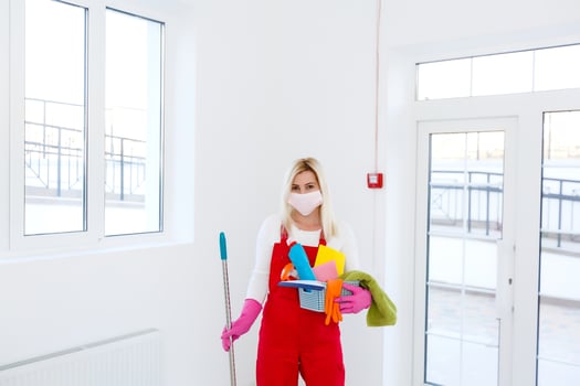 Coronavirus. woman with face mask cleaning and disinfecting her house during coronavirus epidemic. Prevention of COVID-19 infection. Stop coronavirus from spreading. photo