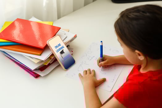 Distance learning online education, little girl writes formulas photo