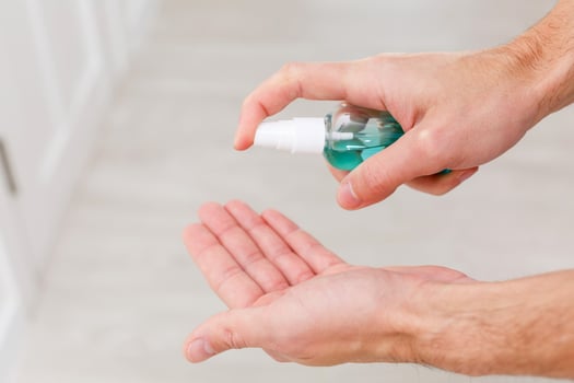 hand is treated with an antiseptic after a door handle photo