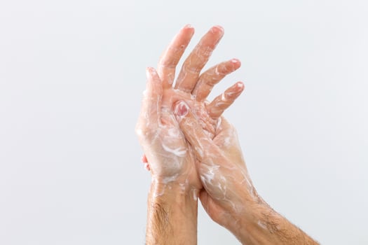 man washing hands isolated over white background photo