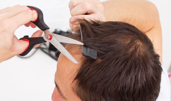 Portrait of a man makes a haircut for himself during quarantine photo