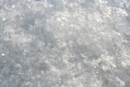 Winter background of snowy surface with melted snowflakes. Natural snow texture. photo