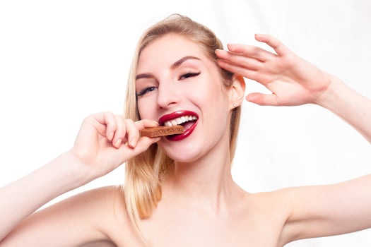 Lovely smiling teenage girl eating chocolate photo