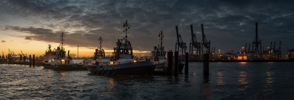 Sunrise in the port of hamburg at a pier for tugboats photo