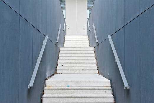 Abstract closeup of the glass-clad facade of a modern building covered in reflective plate glass. Architecture abstract background. Glass wall and facade detail. photo