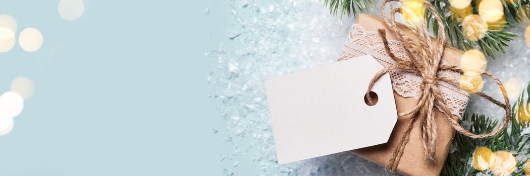 Gift box packed in paper with lace and twine. Eco Christmas decor, banner format photo