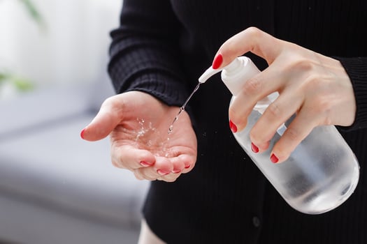 Female hands applying antibacterial liquid soap close up. photo