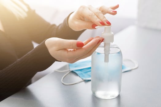 Female hands applying antibacterial liquid soap close up. photo