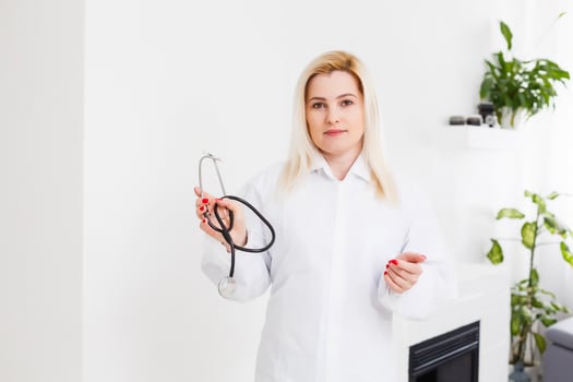 Portrait of a beautiful happy female doctor standing in the hospital photo