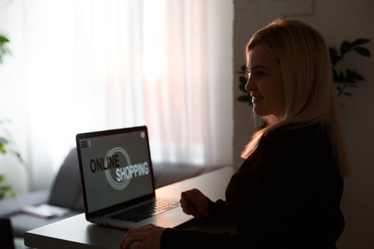 Close up of a woman shopping online in a laptop at home photo