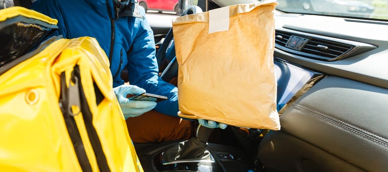 contactless food delivery to customers home. Delivery service worker with thermal backpack quick delivering food at doorstep in quarantine from restaurant, supermarket or cafe . Online ordering food photo