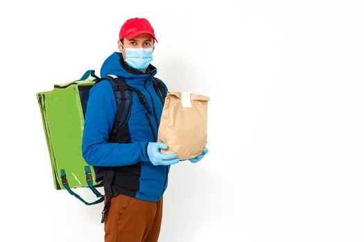 Young courier with thermo bag on white background. Food delivery service photo