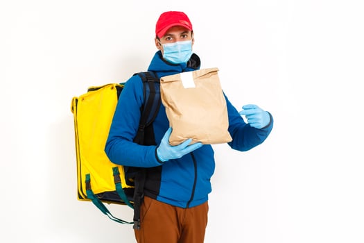 delivery man send food bag at door knob for contactless or contact free from delivery rider in front house for social distancing for infection risk. photo