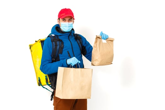 Young courier with thermo bag on white background. Food delivery service photo