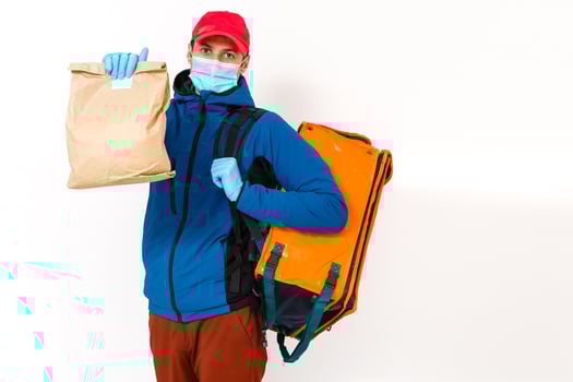 Young courier with thermo bag on white background. Food delivery service photo