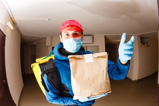 delivery man send food bag at door knob for contactless or contact free from delivery rider in front house for social distancing for infection risk. photo