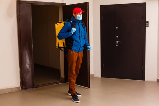 delivery man send food bag at door knob for contactless or contact free from delivery rider in front house for social distancing for infection risk. photo