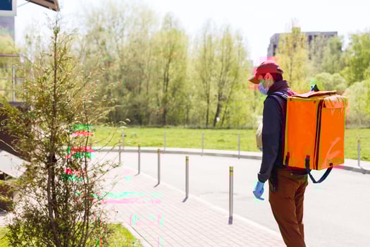 delivery man send food bag at door knob for contactless or contact free from delivery rider in front house for social distancing for infection risk. photo