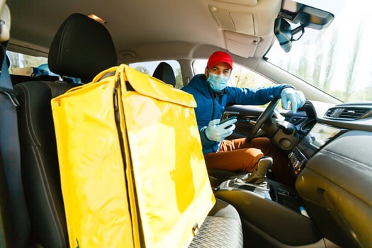 contactless food delivery to customers home. Delivery service worker with thermal backpack quick delivering food at doorstep in quarantine from restaurant, supermarket or cafe . Online ordering food photo