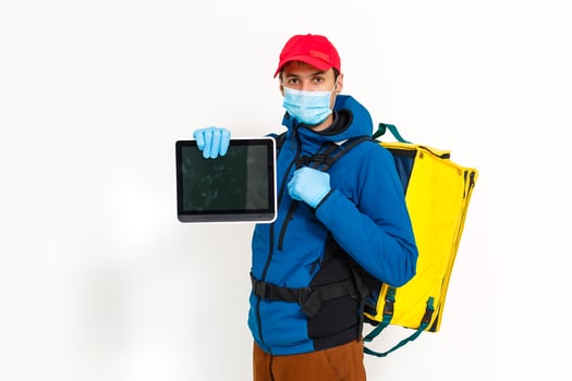 contactless food delivery to customers home. Delivery service worker with thermal backpack quick delivering food at doorstep in quarantine from restaurant, supermarket or cafe . Online ordering food photo