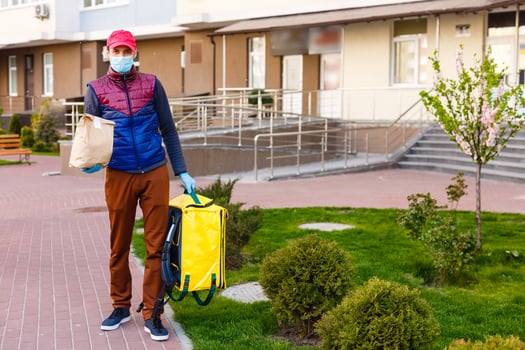delivery man send food bag at door knob for contactless or contact free from delivery rider in front house for social distancing for infection risk. photo