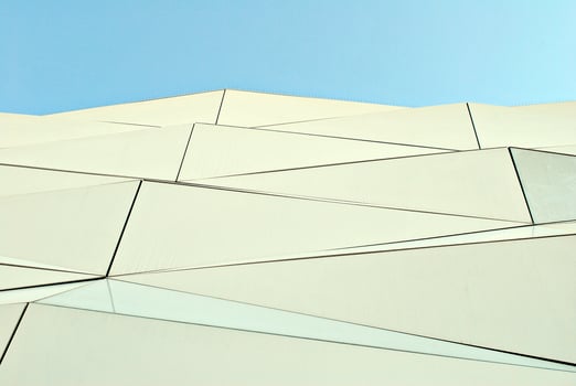 Abstract closeup of the glass-clad facade of a modern building covered in reflective plate glass. Architecture abstract background. Glass wall and facade detail. photo