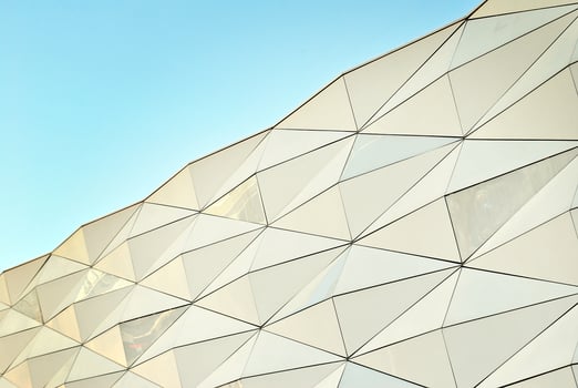 Abstract closeup of the glass-clad facade of a modern building covered in reflective plate glass. Architecture abstract background. Glass wall and facade detail. photo
