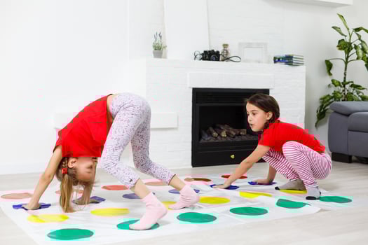 two little girls Having Fun Playing Game On Floor At Home. Siblings Friendship photo