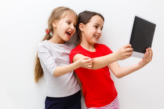 picture of two beautiful girls with tablet pc on white background photo