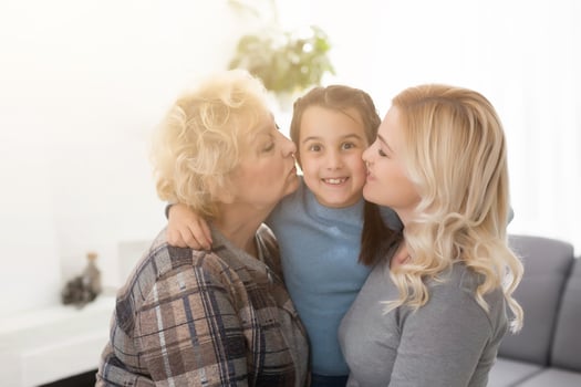 Portrait of three generations of women look at camera posing for family picture, cute little girl hug mom and granny enjoy time at home, smiling mother, daughter and grandmother spend weekend together photo