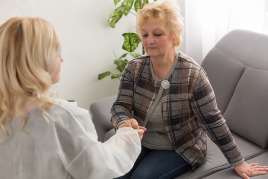 Senior woman with her home caregiver photo