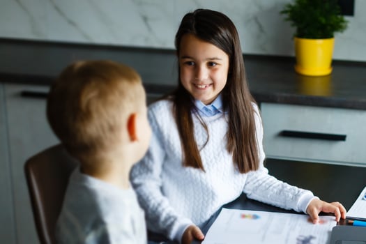 Distance learning online education. Schoolboy and girl studying at home with laptop notebook and doing school homework. photo