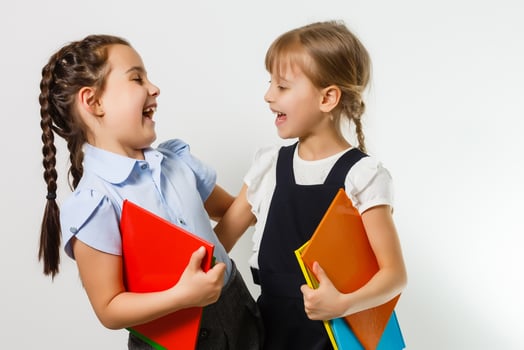 Portrait of two people nice cute lovely charming dreamy attractive cheerful pre-teen girls siblings showing aside ad promotion copy space isolated background photo