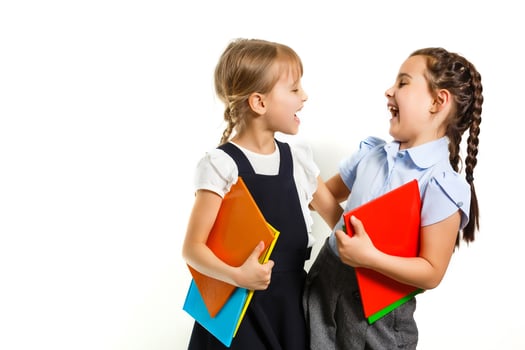 Two little schoolgirls. Education, fashion, friendship concept. photo