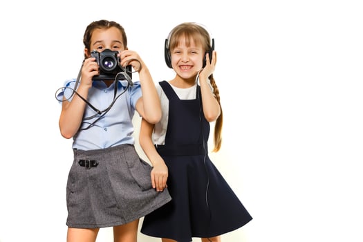Two little schoolgirls. Education, fashion, friendship concept. photo