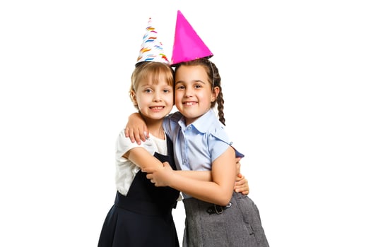 Two birthday girls in shirt blue school uniform dresses hat isolated on white background children studio portrait. Childhood kids education lifestyle concept. Mock up copy space photo