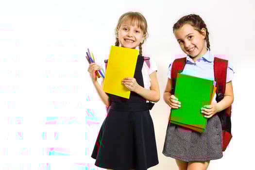 Two little schoolgirls. Education, fashion, friendship concept. photo