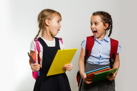 Two little schoolgirls. Education, fashion, friendship concept. photo