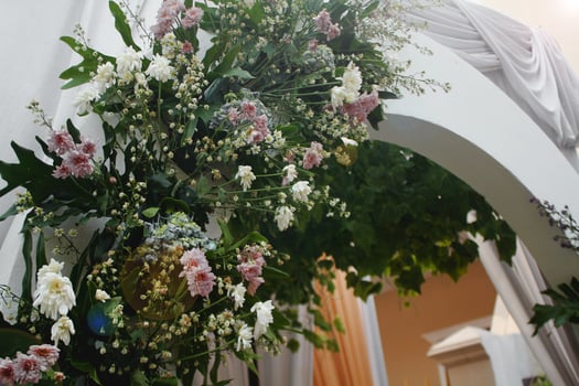 Decorative flowers arranged at the entrance to a wedding event. photo